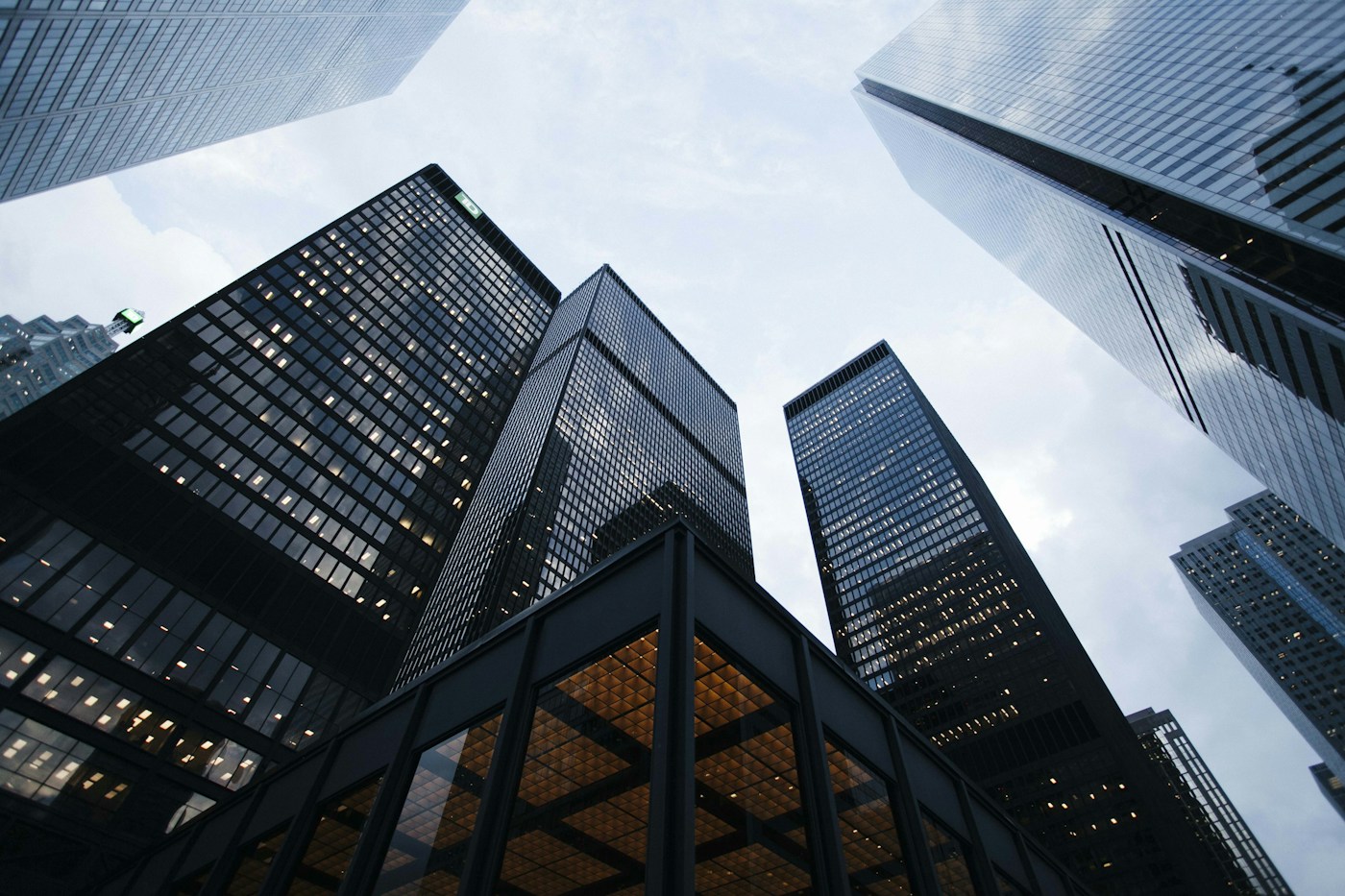 Looking upward between contemporary glass skyscrapers